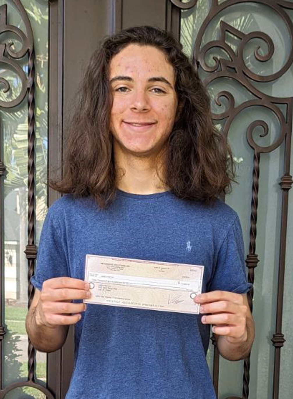 Justin Heyman holding IT Scholarship Award check